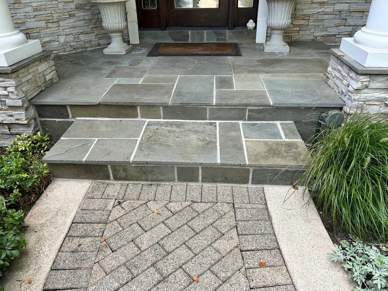 Finished bluestone landing and front steps with mortar joints